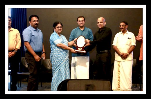 Rajesh Puthanpurayil with his award at an award ceremony