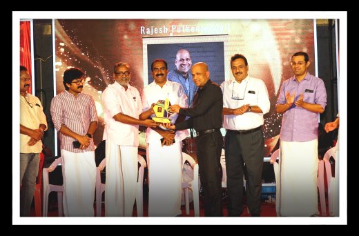 Rajesh Puthanpurayil receiving recognition at an award event